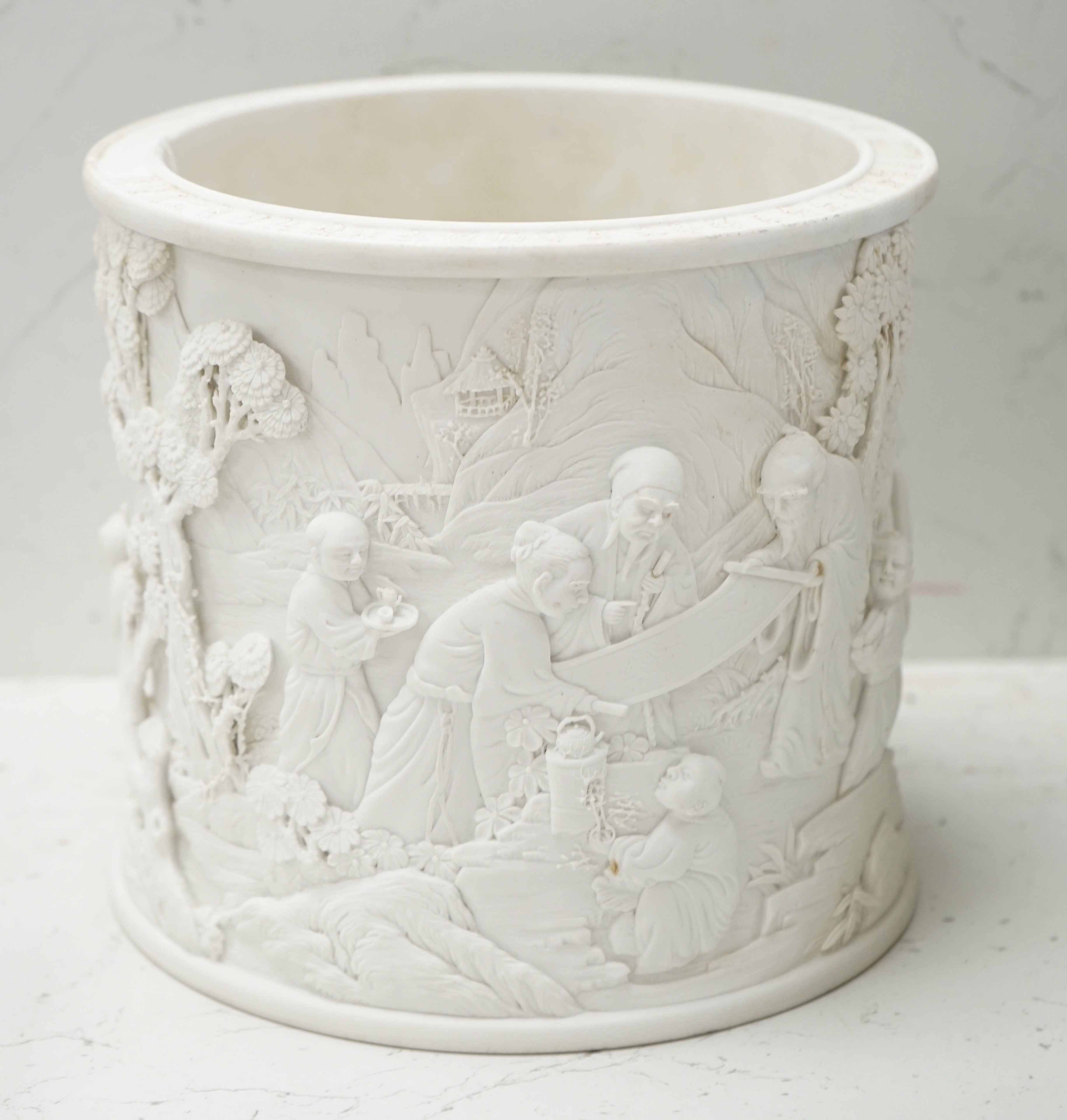 A Chinese biscuit porcelain ‘scholars’ brushpot, Daoguang mark but later, 17cm. Condition - fair to good